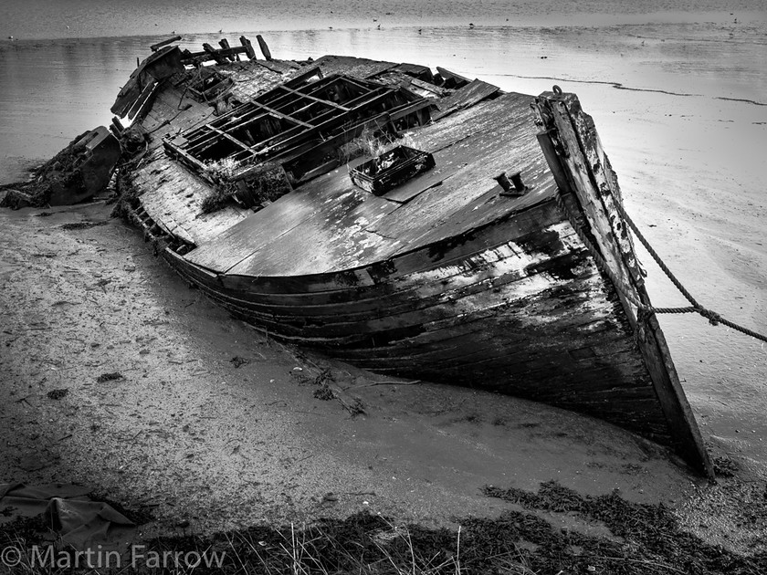 Abandoned 
 Old boat abandoned on shore 
 Keywords: boat,shore,abandoned,rotting,decay,mud,eater,river,low tide,decompose