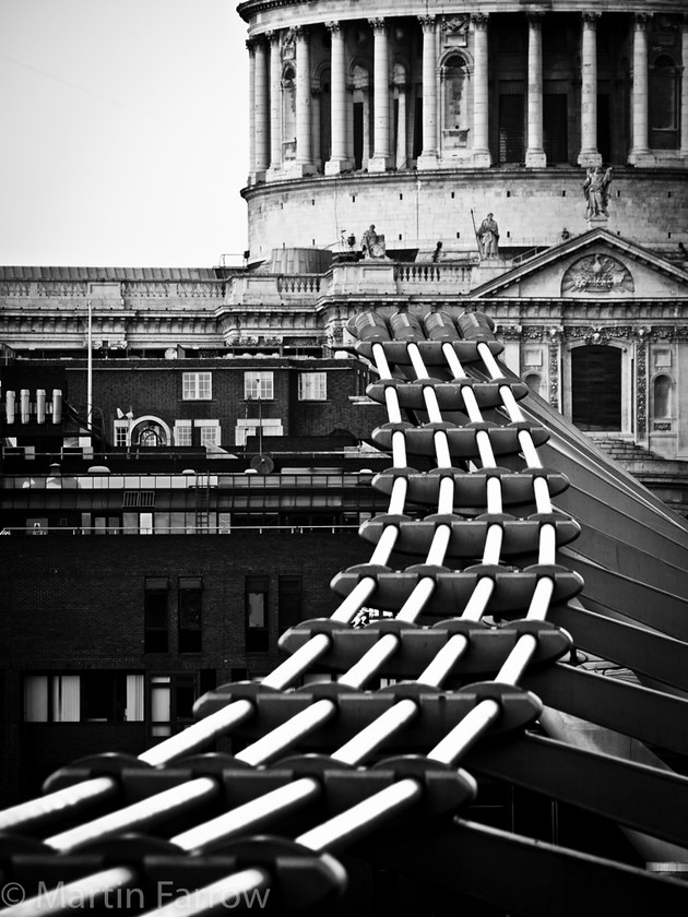 Bridge-to-St-Pauls 
 Detail of Millennium Bridge and St Pauls Cathedral 
 Keywords: London, streets,bridge,wire,building,St Pauls,curve,light