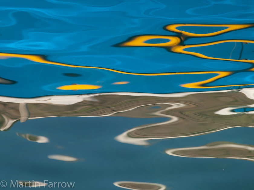 Calm 
 Reflection of boat in calm water 
 Keywords: Chora, Greece, Mykonos, abstract, clear,wave.reflection,blue,yellow,boat,calm,pattern