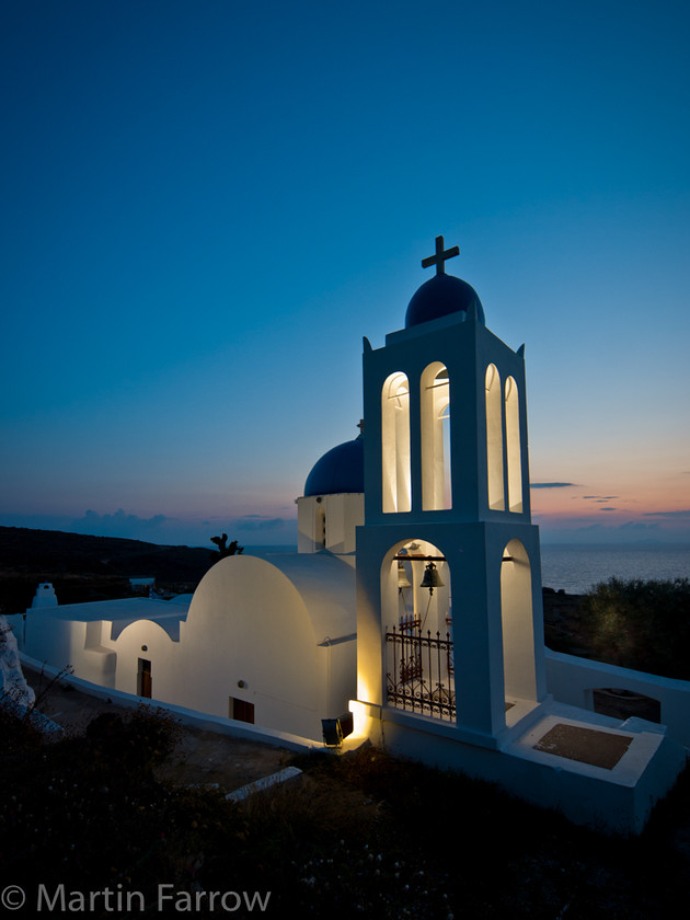 Dawn-Light 
 Lit church at dawn 
 Keywords: Greece, Pori, Santorini, blue, church, sun rise, white,lights,dawn blue,shore,coast