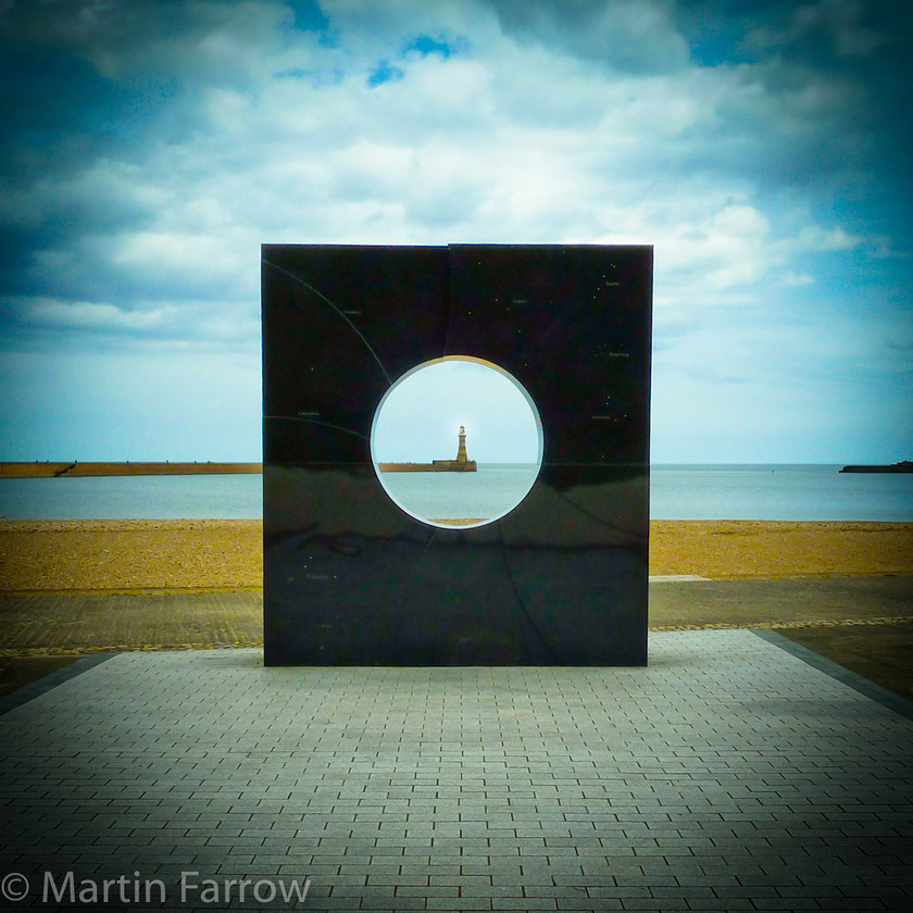 Roker-Lighthouse 
 Lighthouse viewed through sculpture 
 Keywords: Roker, Sunderland, beach, lighthouse, sculpture, sea, water, waves,round,square,sky,black,hole