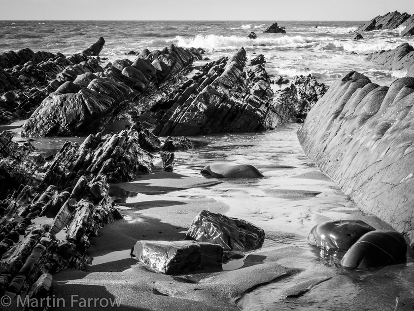 Low Tide 
 Rocky shore at low tide 
 Keywords: Devon, Hartland, North Devon, shore,rocks,low tide,sand,wet,shiny,waves,sea,ocean,jagged,angles