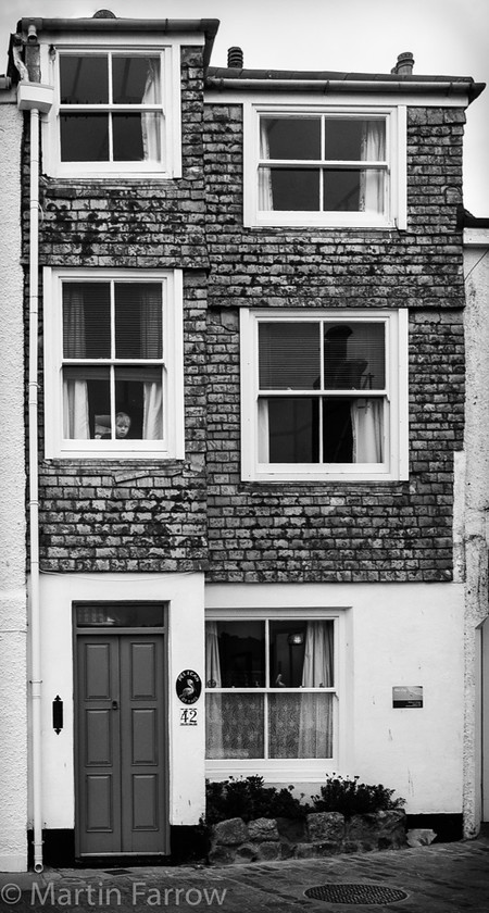 Tall-and-Narrow 
 Tall narrow building, monochrome 
 Keywords: Cornwall, St Ives, building, coast, monochrome, narrow, ocean, old building, sea, shore, tall, terraced, three, tiles, windows