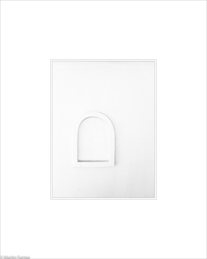 06 Alcove 
 White wall with alcove defines by relief 
 Keywords: ARPS panel fine art white simple abstract graphic architecture alcove relief wall subtle shadow Santorini Greece island