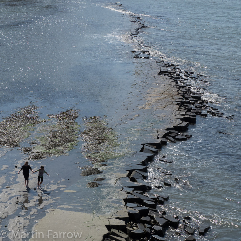 On-The-Shore 
 Two people on rocky shore 
 Keywords: Dorset, Kimmeridge, beach, cliffs, coast, rocks, sea, water,people,two,walking,ocean,shore,broken