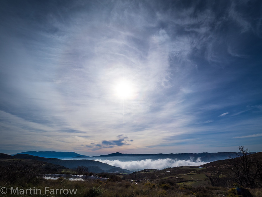 High-and-Low-Cloud 
 Low cloud in valley with thin hogh cloud above and weak sun shining through 
 Keywords: Alpujarras, Andalucia, Mountains, countryside, high, hills, sky, spain, spring, steepclouds, sun, valley