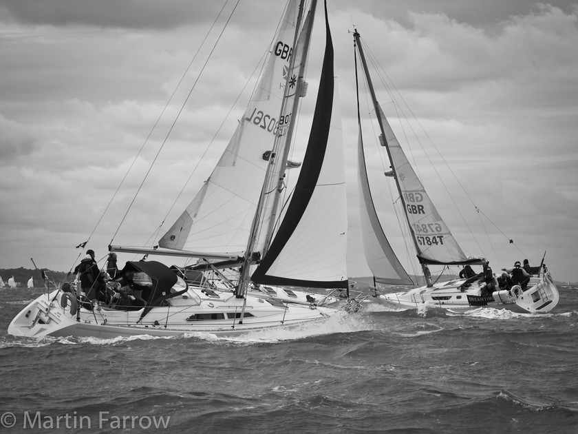 Beating 
 Yachts beating in race with strong wind 
 Keywords: Battle of Britain, RAFYC, boats, racing, regatta, sailing, sea, water, waves, yachts,wind,strong,three,close,ocean,sail