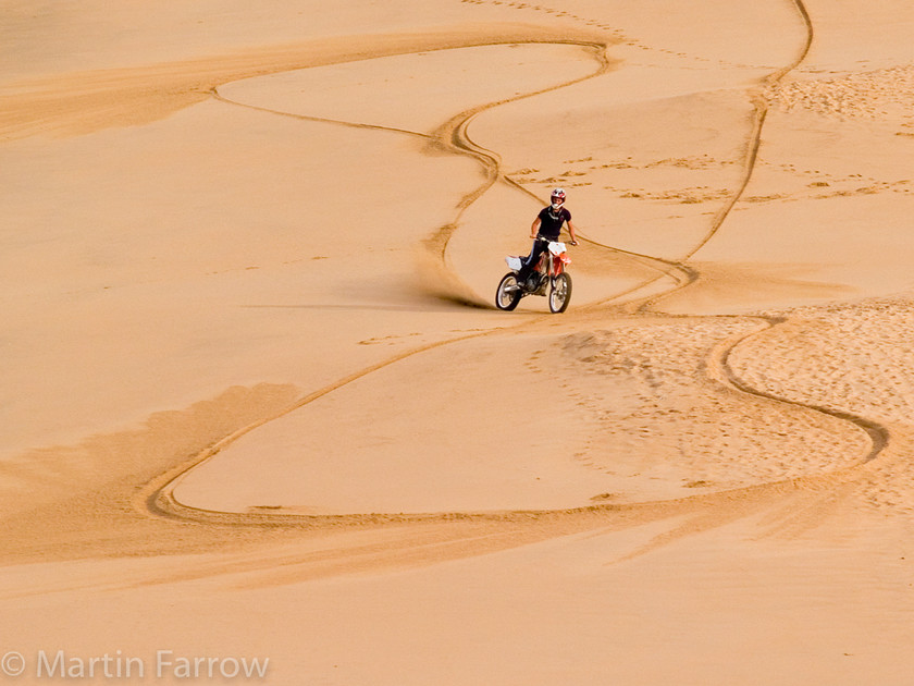 Bike-Trails 
 Biker creating trails in the sand 
 Keywords: beach, sand,bike,trails,tracks,beach,shore,motor bike