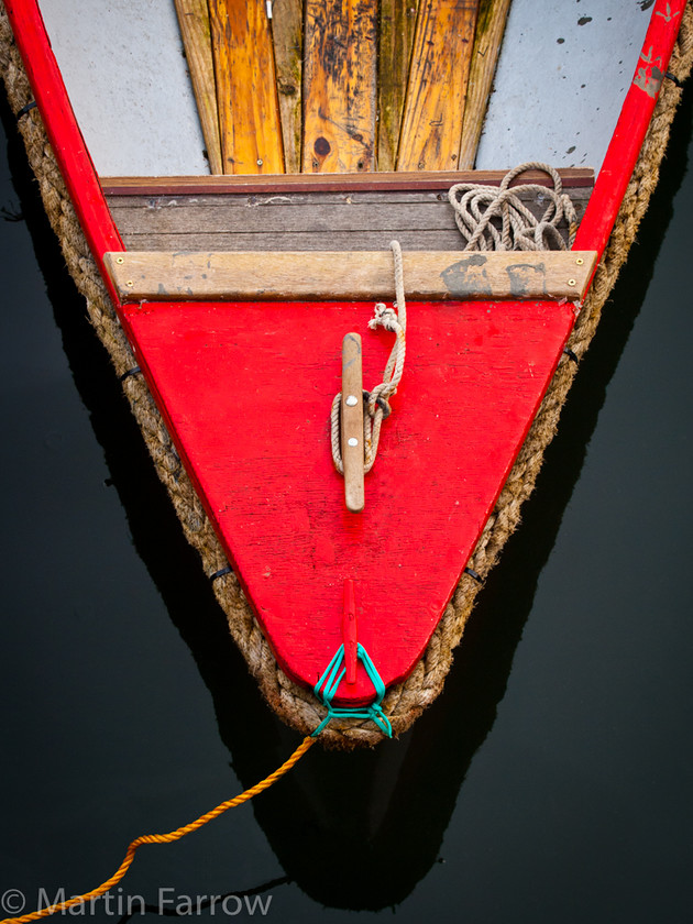 Red-Boat 
 Looking down on bow of red boat 
 Keywords: Brixham, Devon, boats, harbour, sea,red,bow,moored,rope,wood,water,calm