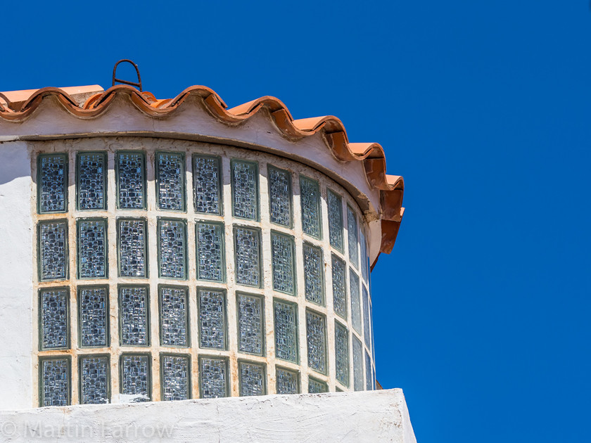 Curved-Window 
 Curved window of building with tiled roof under clear blue sky 
 Keywords: Canaries, Gran Canaria, Mountains, blue, curve, round, windows