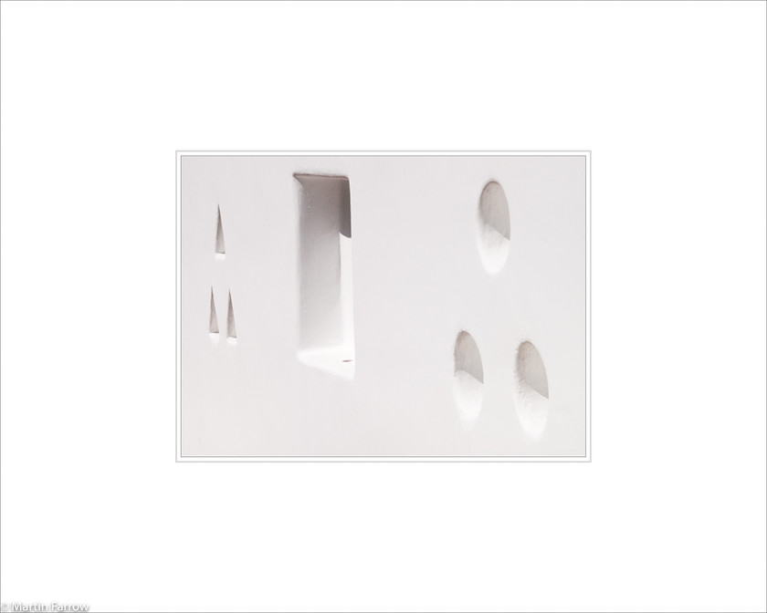 09 Geometrical-Shapes 
 White wall with geometrically shaped holes 
 Keywords: ARPS panel fine art white simple abstract graphic architecture wall holes geometry geometrical gap recess Santorini Greece island