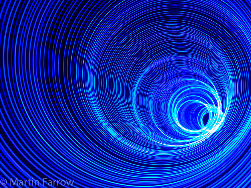 Vortex 
 Swirl of receding lights 
 Keywords: Littleton, light painting, lights, night, workshop, swirl,vortex,blue,circles