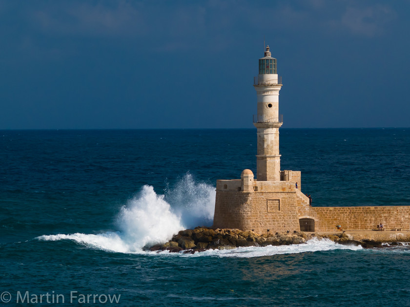 Lighthouse-Waves 
 Lighthouse with crashing wave 
 Keywords: beach, clouds, lighthouse, sky,wave,sea,ocean,shore,foam,white,harbour