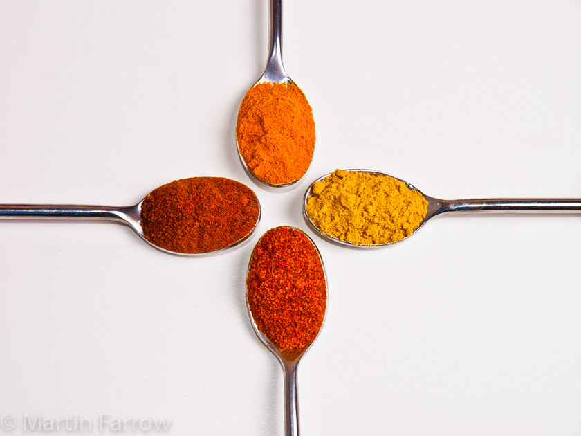 Spice-Cross 
 Cross of spoons with coloured spice 
 Keywords: flavouring, seasoning, spices, still life, studio,spoon,orange,yellow,cross