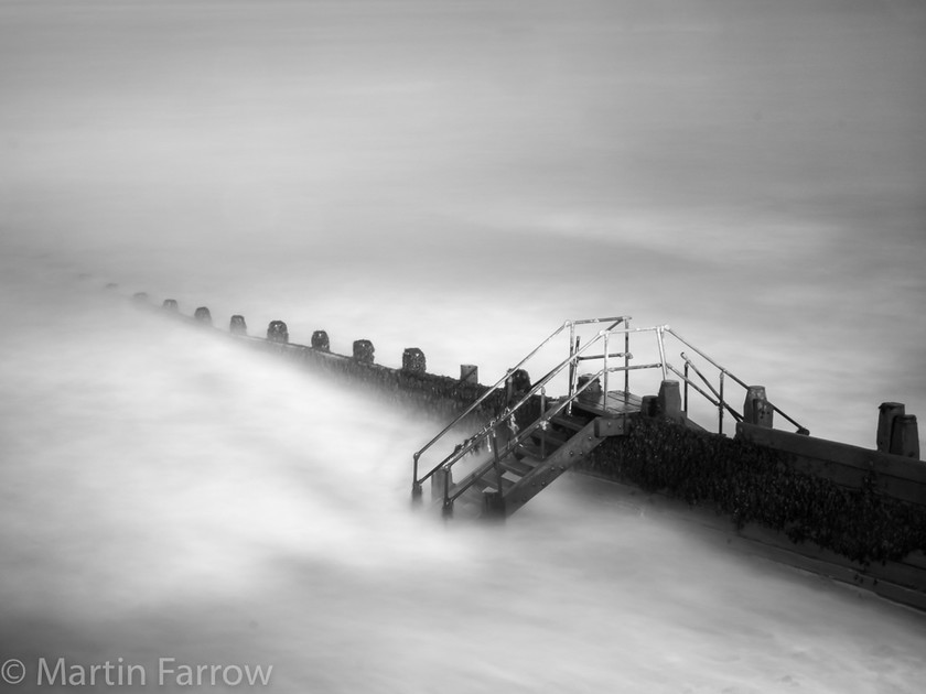 Over-the-Groyne 
 Groyne with misty water 
 Keywords: Cromer, Norfolk, beach, coast, groynes, sea, waves, winter,ocean,mono,slow,long