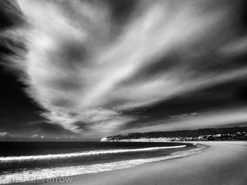 Curves-mono 
 Curved clouds over curved beach 
 Keywords: beach, clouds, sky,curve,water,sea,ocean,waves,sand,cliffs,land